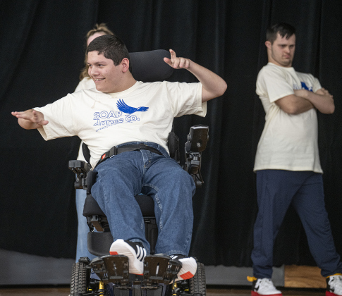 Georgetown High School student Anthony Miller joins members of his SOAR Dance Company onstage during the Georgetown I.S.D.  State of the District event, held at district headquarters on Thursday, March 13, 2025.  SOAR stands for Sharing Opportunity Through Adaptive Rhythm.