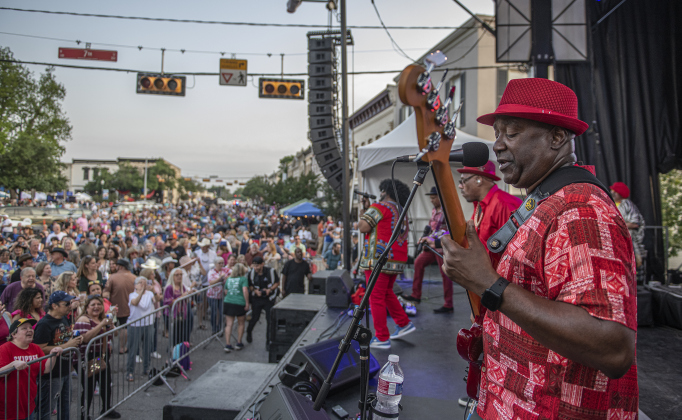 Dysfunkshun Junkshun performs from a stage at 7th Street and Austin Avenue  at the opening night of the Red Poppy Festival on Friday, April 26, 2024.