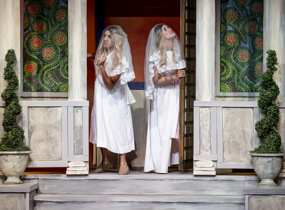AJ Reyes, left, as Hysterium, and Teddi Iley, right, playing Philia,  are pictured in a Thursday, March 20, 2025 dress rehearsal of “A Funny Thing Happened On the Way to the Forum,” playing on the Palace main stage through April 19th.    Photo by Andy Sharp.