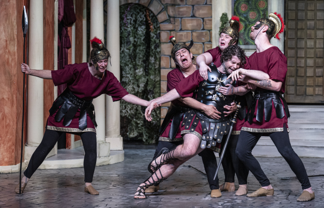 Ryan Rhue, center, as Miles Gloriosus, is assisted by Protean cast members, including Meredith Brand, left, Nick Riley, second from left, Brooke McGaughey, second from right, and Matthew Hubble, right, in a Thursday, March 20, 2025 dress rehearsal of “A Funny Thing Happened On the Way to the Forum,” playing on the Palace main stage through April 19th.    Photo by Andy Sharp.