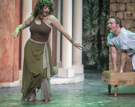Sheree Bristoll, left, as Vibrata, and Nathan Clemenson, playing Prologus,  are pictured in a Thursday, March 20, 2025 dress rehearsal of “A Funny Thing Happened On the Way to the Forum,” playing on the Palace main stage through April 19th.    Photo by Andy Sharp.