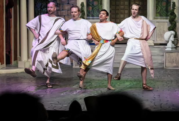 Stephen Quinn, left, as Senex, Nathan Clemenson, second from left, as Prologus, AJ Reyes, second from right, as Hysterium, and Korben Lindstrom, right, playing Lycus,  are pictured in a Thursday, March 20, 2025 dress rehearsal of “A Funny Thing Happened On the Way to the Forum,” playing on the Palace main stage through April 19th.    Photo by Andy Sharp.