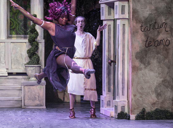 Niona Garfield, front, as Panacea, and Korben Lindstrom, playing Lycus,  are pictured in a Thursday, March 20, 2025 dress rehearsal of “A Funny Thing Happened On the Way to the Forum,” playing on the Palace main stage through April 19th.    Photo by Andy Sharp.