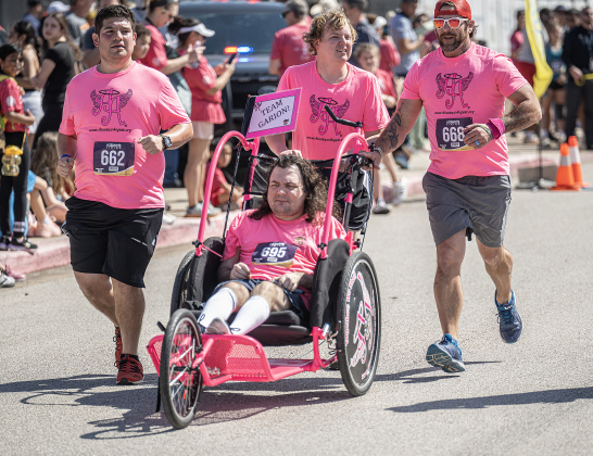 Ainsley’s Angels team member Garion Champagne is assisted by teammates Triston Peiris, Taylor Scruggs and Travis Tobias as they near the 5K race finish line during the 13th Annual Chase the Chief, held Sunday, March 2, 2025 at East View High School.   2,000 people were registered for the one-mile fun run and 5K event.   Proceeds from the races support physical education programs in Georgetown.   Photo by Andy Sharp.