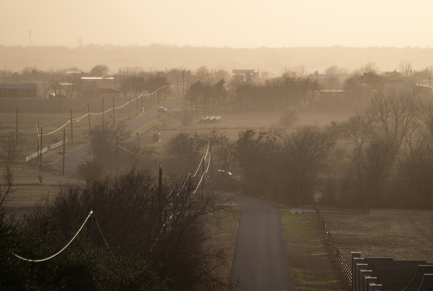 Strong winds led to a dusty landscape as seen along County Road 124 near Weir on Tuesday, March 4, 2025.   Photo by Andy Sharp.  