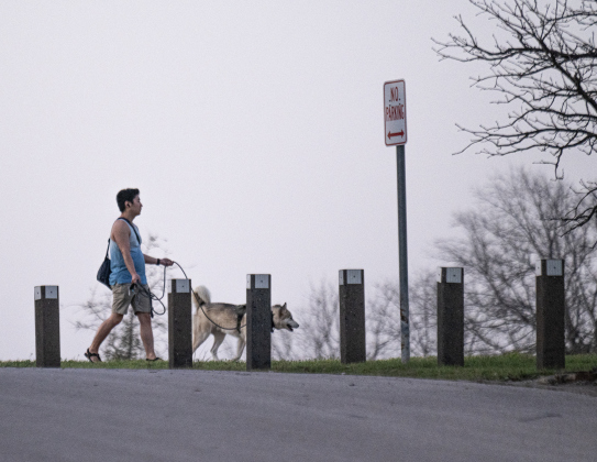 Nathan Bryant and his dog Lowkey enjoy a walk at Berry Springs Park &amp; Preserve  on a windy Tuesday, March 4.