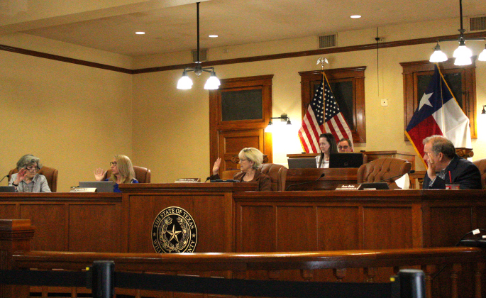 The Williamson County Commissioners Court on March 14 — from left Terry Cook, Cynthia Long, Valerie Covey and Russ Boles — set the interview date for interim county judge candidates. Photo by Nalani Nuylan.