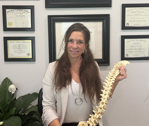 Dr. Shanna Jackson sits in her office in front of her degrees and certificates. She has earned her doctorate from the Sherman College of Chiropractic, her BAAS from the University of North Texas and completed the animal chiropractic program at Parker University. Photo by Abbey Archer