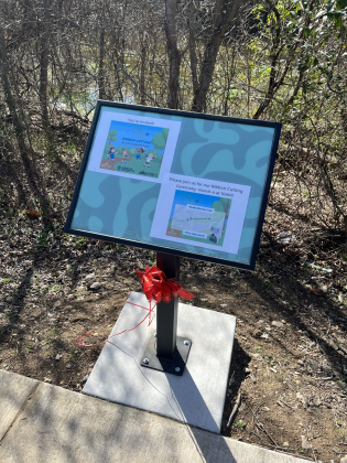 : A new permanent storywalk panel displays information about the March 4 event.