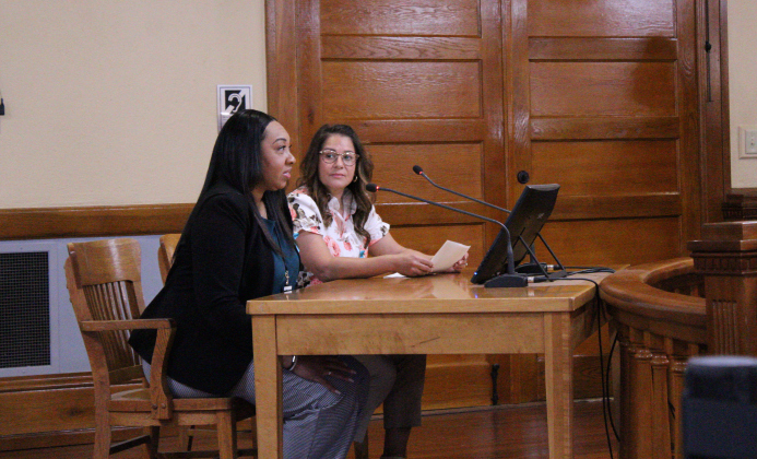 Kelly Herandez, back, and Kyla Coleman, senior victims assistant coordinator for the Hutto Police Department, front, explain the importance of recognizing April as Sexual Assault Awareness Month during the April 1 Commissioners Court meeting. Photo by Nalani Nuylan.