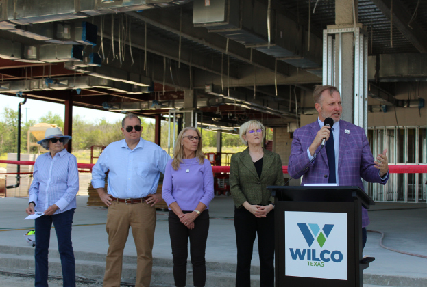 County Commissioners – from left Terry Cook, Russ Boles, Cynthia Long, Valerie Covey – listen to Incoming County Judge Steven Snell give a speech at the new county headquarters’ topping off ceremony, April 11. Photo by Nalani Nuylan.