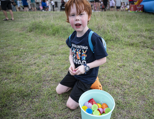 6-year-old Brantley Pogue relaxes after gathering eggs  during the annual Easter Egg Hunt conducted by Georgetown Church of the Nazarene  on Saturday, April 19.