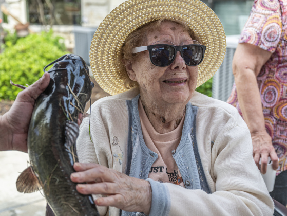 99-year-old Ruby Fisher was okay with touching the fish she caught, but passed up an opportunity to kiss it  during the 22nd Annual Fishing Tournament held at Taylor’s SPJST Senior Living  on Thursday, April 24.
