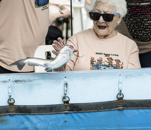 100-year-old Bertha Pistone reacts to a fish she caught during the 22nd Annual Fishing Tournament held at Taylor’s SPJST Senior Living  on Thursday, April 24, 2025.   A large tank was brought in, filled with water and loaded with 400 pounds of catfish.  Volunteers and staff were on hand to help with the fish as they were caught. The tournament continues Friday, culminating with a fish fry here at 6 p.m. Photo by Andy Sharp.