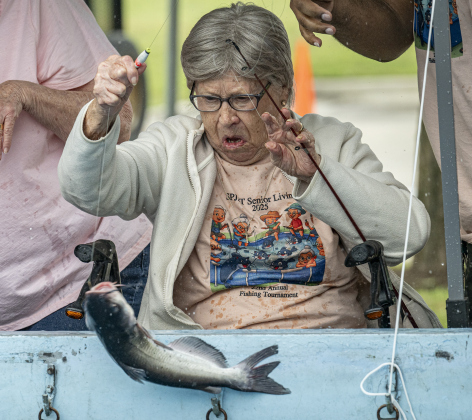 Sybil Naizer, 91, brings in a fish  during the 22nd Annual Fishing Tournament held at Taylor’s SPJST Senior Living  on Thursday, April 24.