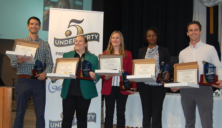 Five Under 40 award recipients, from left, Sam Gallardo, Tori Clark, Kim McAuliffe, Marian Diop and Michael Pickel hold their Congressional Certificates and award from the Rotary Club and Chamber of Commerce. (Photo by Kaitlyn Wilkes)