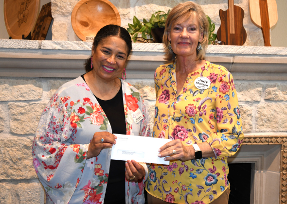 Mommie Support Network Executive Director Alicea Jones accepts a check from WHO Vice President Judy Madson.