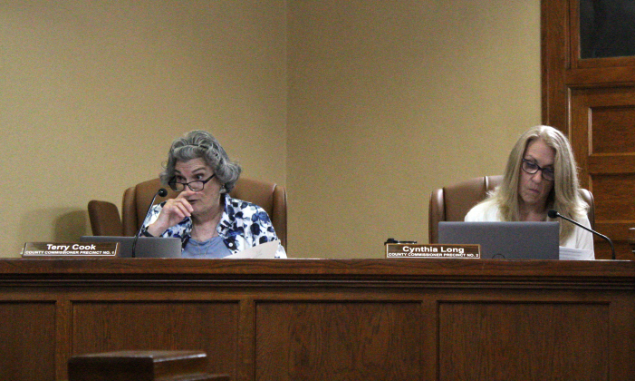 County Commissioner Terry Cook, left, reads the proclamation to designate May 5 - 9 as Air Quality Awareness Week during the May 6 commissioners court meeting. Photo by Nalani Nuylan.