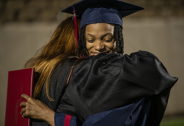 East View Assistant Principal Sami McLane, left, hugs graduate Kobey Fontenot after she received her diploma  during commencement for East View High School at the Georgetown ISD Athletic Complex on Friday, May 23, 2025.  489 East View seniors received their diplomas.    Photo by Andy Sharp.