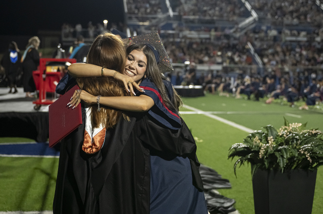 Madelyn Tomasone shares a hug with  East View Assistant Principal Sami McLane after receiving her diploma  during commencement for East View High School at the Georgetown ISD Athletic Complex on Friday, May 23, 2025.  489 East View seniors received their diplomas.    Photo by Andy Sharp.