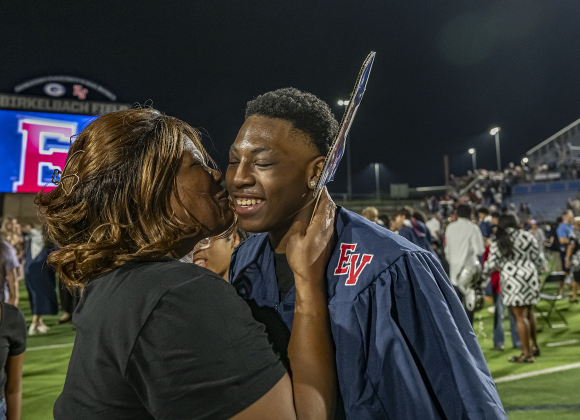 Donna Bellard, left, kisses grandson Tayden Minix after he received his diploma during  commencement for East View High School at the Georgetown ISD Athletic Complex on Friday, May 23, 2025.  489 East View seniors received their diplomas.    Photo by Andy Sharp.