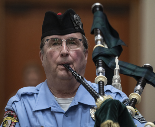 Todd Bircher, with Georgetown Fire Department Pipes &amp; Drums, joins in the playing of “Amazing Grace” during the Memorial Day ceremony in Sun City on Monday, May 26, 2025.  Approximately 600 were in attendance.  Rain chances moved the event indoors.   Photo by Andy Sharp.