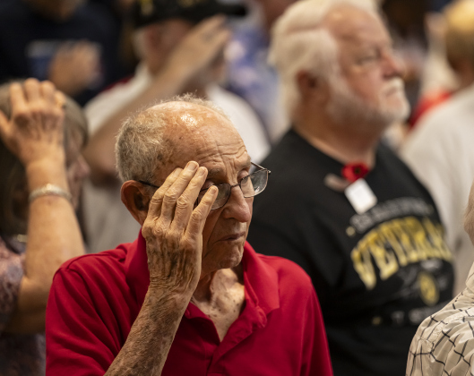 World War II veteran (Navy) Bill Harper, 100, salutes during the Presentation of the Colors during  the Memorial Day ceremony in Sun City on Monday, May 26, 2025.  Approximately 600 were in attendance.  Rain chances moved the event indoors.   Photo by Andy Sharp.