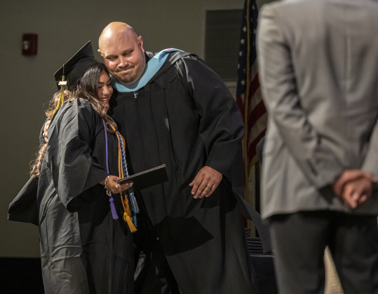 Valedictorian Leslie Hernandez gets a hug from principal Bretton Schulz during the Richarte High School commencement ceremony held at the Klett Performing Arts Center  on Thursday, May 22, 2025.