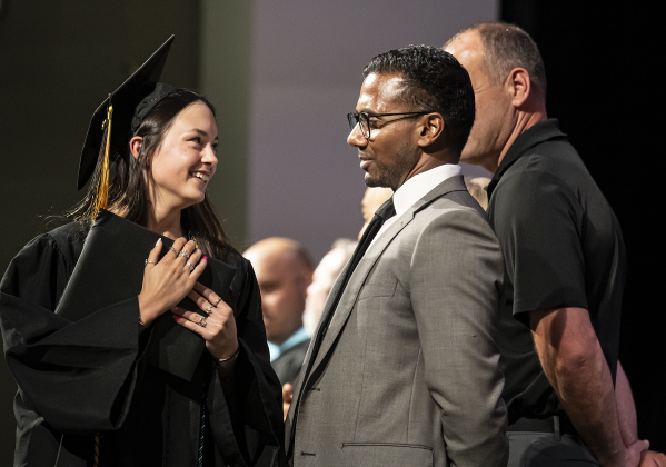 Lucy Dean Hollon is congratulated by Superintendent Devin Padavil  during the Richarte High School commencement ceremony.