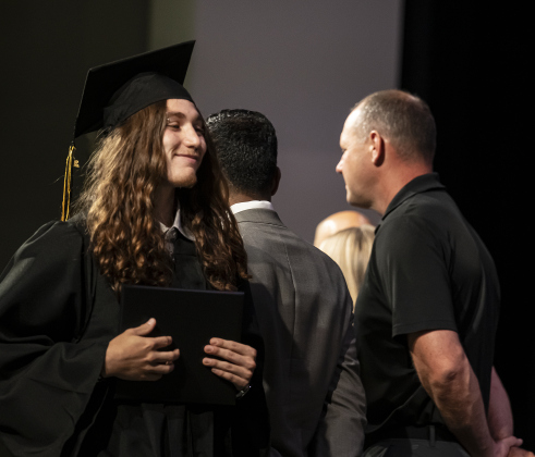 Alec Everett Lunday smiles after receiving his diploma during the Richarte High School commencement ceremony.