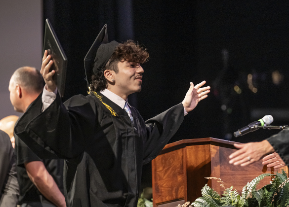 Crispin Ayden Perez is congratulated after receiving his diploma during the Richarte High School commencement ceremony.