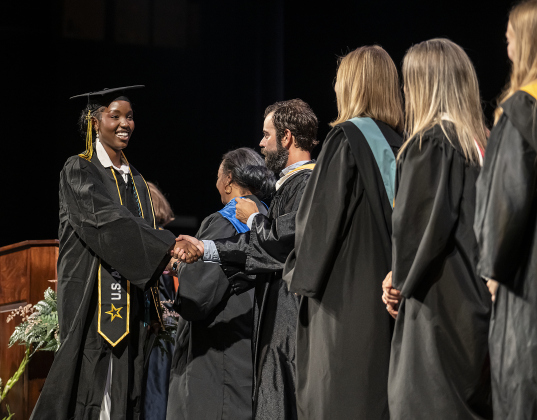Gift Mbabazi Semahoro is acknowledged by Richarte staff members after receiving her diploma during the Richarte High School commencement ceremony held at the Klett Performing Arts Center  on Thursday, May 22, 2025.