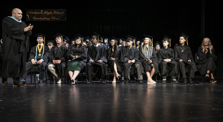 Principal Bretton Schulz, left, acknowledges his seniors with applause during the Richarte High School commencement ceremony held at the Klett Performing Arts Center  on Thursday, May 22, 2025.
