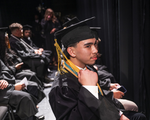 Salutatorian Nathaniel Nguyen joins classmates backstage during the Richarte High School commencement ceremony.