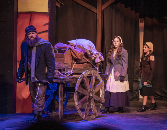 Brian Joyce, left, as Tevye, Eden Cessac, center, playing Shprintze, and Lovelyn Cessac, right, as Bielke, are shown in a photo from the dress rehearsal for the Palace production of “Fiddler on the Roof”  on Thursday, May 29, 2025.  The play will run through July 6th on the Springer main stage.    Photo by Andy Sharp.