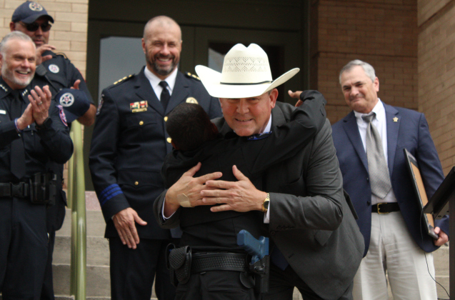 After becoming an Honorary Sheriff's Deputy, DJ gives Sheriff Lindemann a hug.