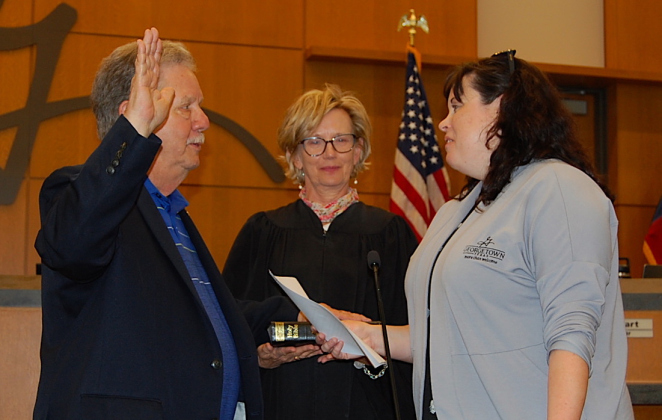 Ron Garland was joined by District Court Judge Betsy Lambeth, center, as he was sworn in by City Secretary Robyn Densmore.