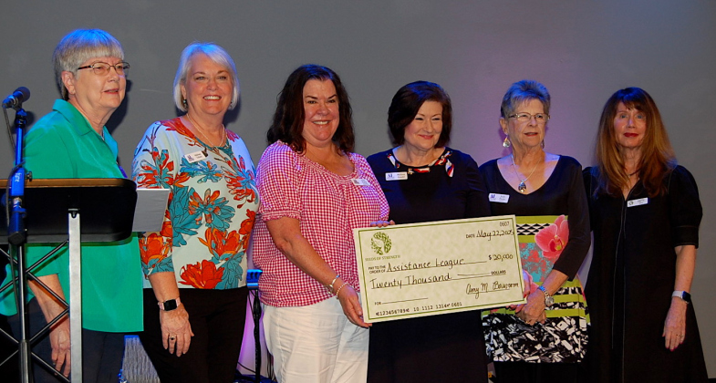 From left, Seeds of Strength Nominating Committee Chair Laura Packard, was joined by Malissa Tritsch, Anna Warren, Melissa Gould and Judy Swainfrom the Assistance League. Seeds of Strength Patty Moore, right, helped Ms. Packard give out the checks. (Photos by Kaitlyn Wilkes)