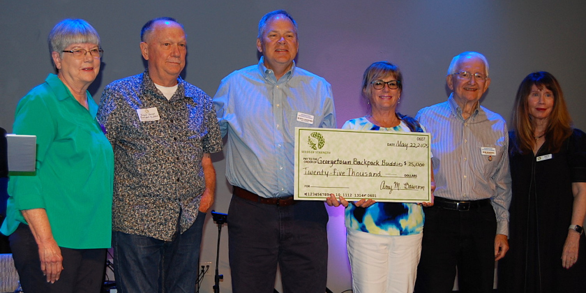 President of Backpack Buddies Rusty Langford, center, said this grant will provide 130 students with 40 nutritious weekend food packs.
