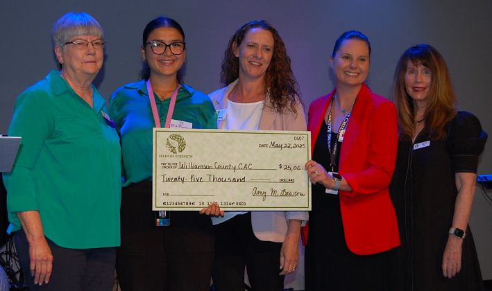 Mia Martinez, second from left, Kerrie Stannell, center, and Tori Algiere, second from right, accepted the check for the Williamson County Children’s Advocacy Center.