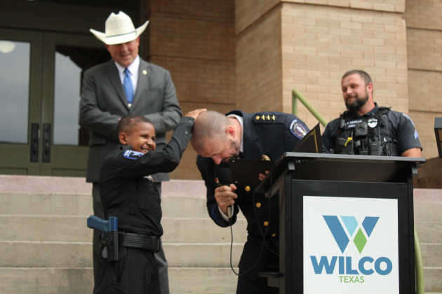 Before taking the oath with Chief Tchida, DJ rubs his head for good luck.