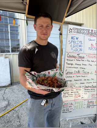 Owner Dylan Grazioplene holds a brisket taco, The Killer Taco’s top-selling menu item. Photo by Abbey Archer