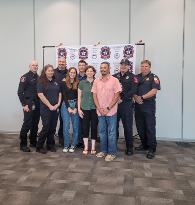Israel Chavez, in red, poses with his family and the  Williamson County Emergency Medical Services crew that aided him when he had a sudden cardiac arrest. Photo by Nalani Nuylan.