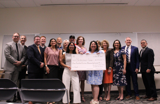 Staff and volunteers of Yesterday’s Gone are presented with a $114,000 check from The Church of Jesus Christ of Latter-day Saints Round Rock Stake and Round Rock East Stake in the Georgetown Public Library, Monday morning. Photo by Nalani Nuylan.