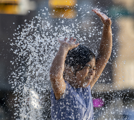 8-year-old Sophia Vargas cools off in  the splash pad at Heritage Square Park.