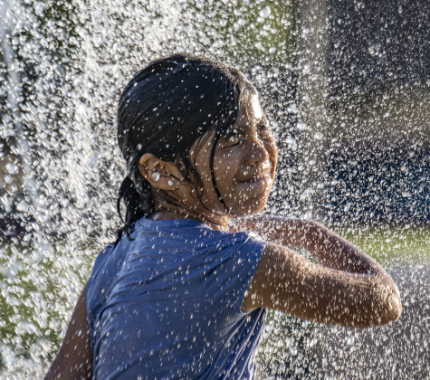Sophia embraces cool water during a visit to  the splash pad at Heritage Square Park on Tuesday, June 17.