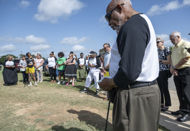 Reverend Dr. Ron Swain, right,  joins others for the Lord's Prayer during  the unveiling of an historical marker at Citizens Memorial Garden Cemetery during a ceremony held  on Juneteenth, Thursday, June 19, 2025.