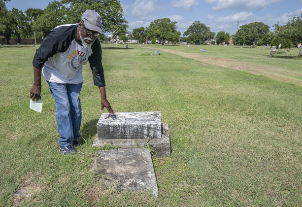 Georgetown Cultural Citizen Memorial Association member Tyrone Adams spends time looking at gravesites at  the unveiling of an historical marker at Citizens Memorial Garden Cemetery during a ceremony held  on Juneteenth, Thursday, June 19, 2025.
