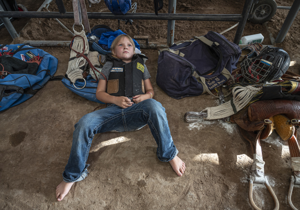 7-year-old Rylee Nalley of Rochelle, Texas rests up before taking part in Mutton Bustin’ at  the Bill Pickett Youth Rodeo, held at the Williamson County Expo Center  on Saturday, June 21, 2025.  Now in its second year, the rodeo showcases athletes 18 or younger. The event is coordinated by the Bill Pickett Youth Rodeo Association.     Photo by Andy Sharp.