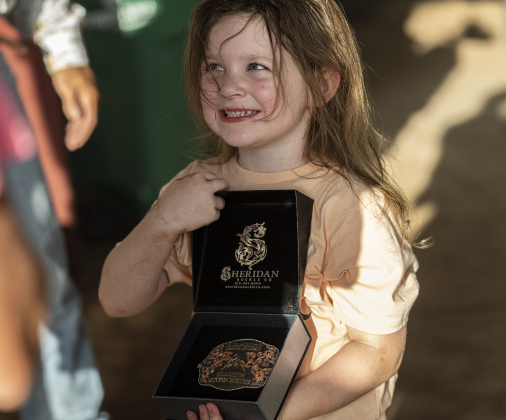 5-year-old Indie Parnell of Temple proudly shows off the buckle she won for being the top competitor in Mutton Bustin’ at  the Bill Pickett Youth Rodeo, held at the Williamson County Expo Center  on Saturday, June 21, 2025.  Now in its second year, the rodeo showcases athletes 18 or younger. The event is coordinated by the Bill Pickett Youth Rodeo Association.     Photo by Andy Sharp.